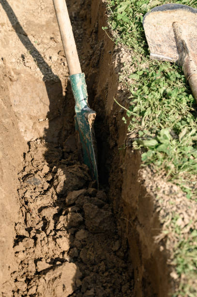 istock A man shovels a trench for drainage and sewage. 1960734399