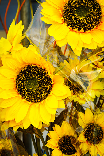 Decorative yellow flowers of sunflower. Artificial plants for interior decoration.