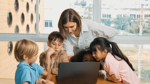 istock Cute girl programing system while surround with teacher and friend. Erudition. 1960748053