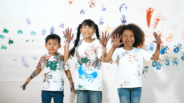 istock Diverse students put hands up together show colorful stained hands. Erudition. 1960749108
