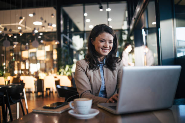 istock Beautiful woman using laptop in cafe 1960759124