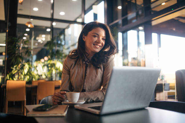 istock Beautiful woman using laptop in cafe 1960762763