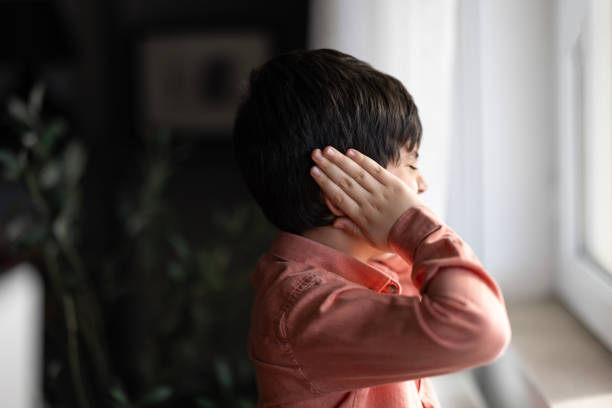 istock Sad child covering his ears with hands during parents quarrel. 1960772622