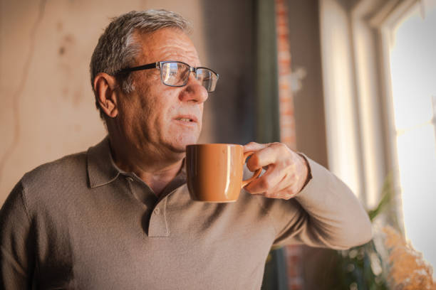 A lonely man holding a coffee cup in his hand