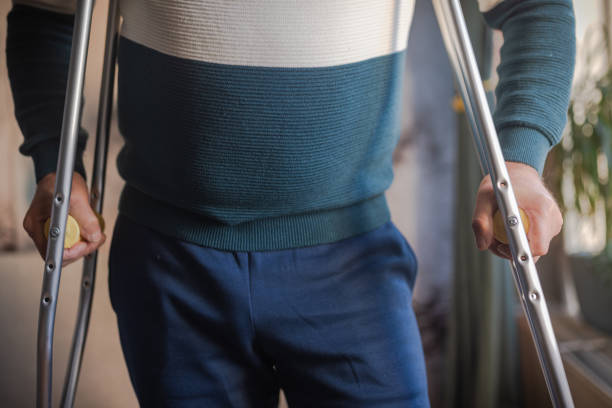 istock Disabled person walks with crutches 1960794637