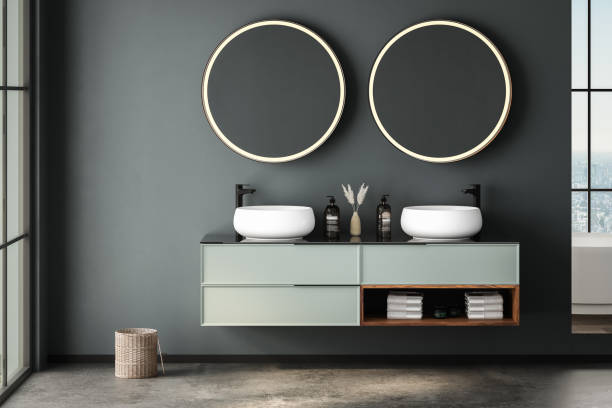 istock Modern bathroom interior with concrete floor, white oval bathtub and two sinks, front view. Minimalist bathroom with modern furniture and city view. 1960817111
