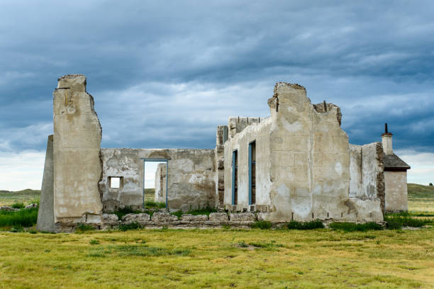 Hospital ruins at Fort Laramie National Historic Site in Wyoming stand high against the green grass and dark, stormy sky.