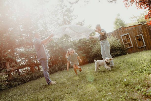 istock Family of Three Playing Outside 1960820283