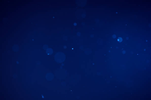 istock Dust particles as bokeh in navy lighting 1960827534