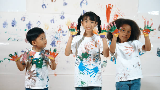 istock Diverse students put hands up together show colorful stained hands. Erudition. 1960833268