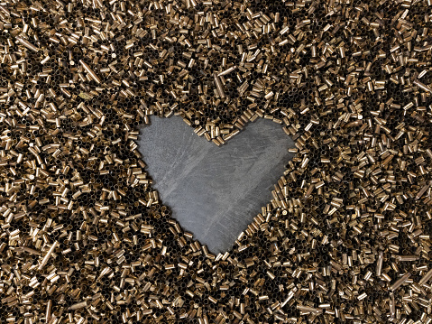 A heart made of gun casings, close-up photo. High quality photo