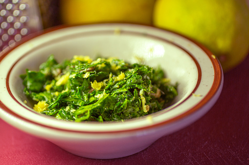 A view of a bowl of gremolata in a lifestyle kitchen setting.
