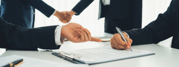 istock Two business executive shake hand in boardroom for merger and acquisition. Shrewd 1960864641