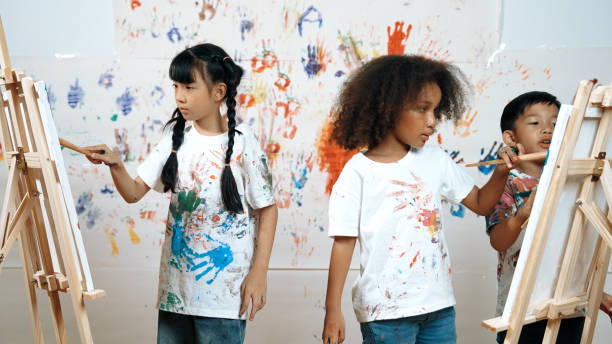 istock Diverse student painted or draw canvas at stained wall in art lesson. Erudition. 1960879899