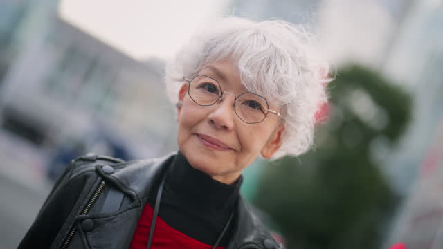Portrait of beautiful and confident Asian senior woman in city