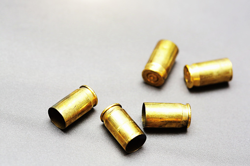 Brass cartridge cases on a gray background with copy space.