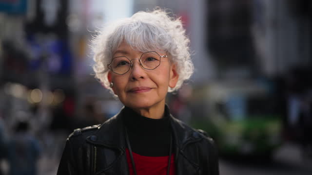 Portrait of beautiful and confident Asian senior woman in city
