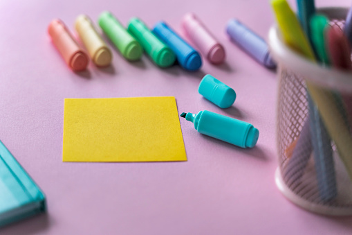 Top view office desk with  office supplies and sticky note.