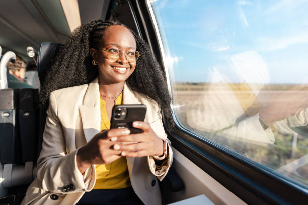 istock African American woman in train, using phone 1960964773