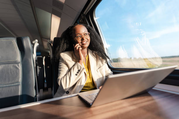 istock Young businesswoman talking on the phone during a train ride 1960964775