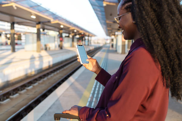 istock African American woman using phone on a train station 1960965286