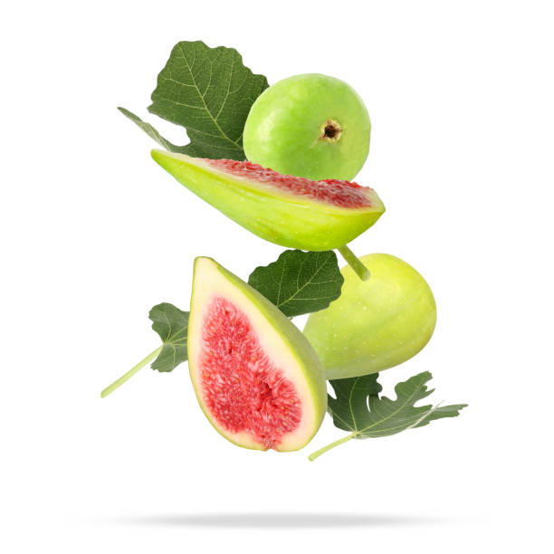 istock Ripe figs and green leaves falling on white background 1960975913