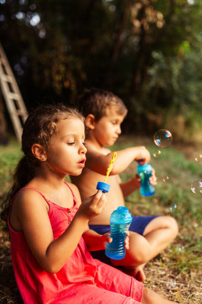 istock Children blowing soap bubbles and have fun 1960989279