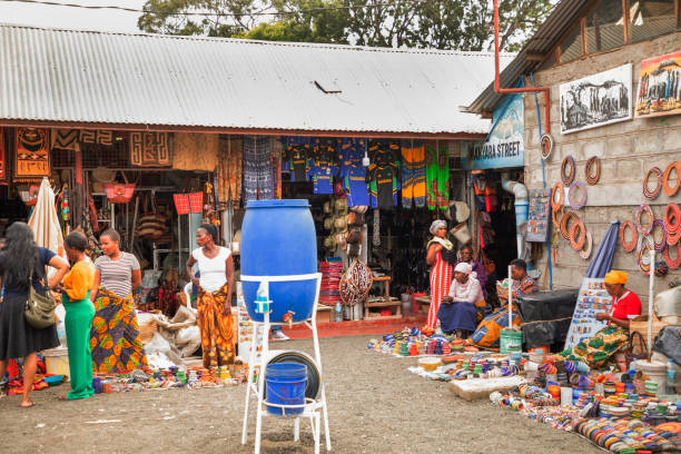 Arusha,Tanzania, Africa.02 february 2022. African masks, beaded bracelets, necklaces, Tanzanian national clothes, bags woven from natural material displayed and ready for sale. Calendars and tourism