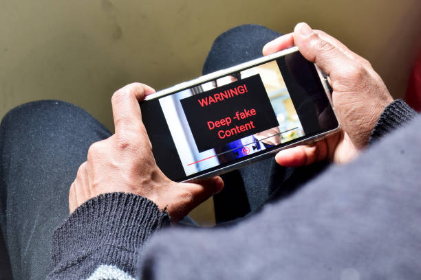 istock Person got potential deep fake content message during watching a footage on his mobile phone. Selective focus. 1961023479