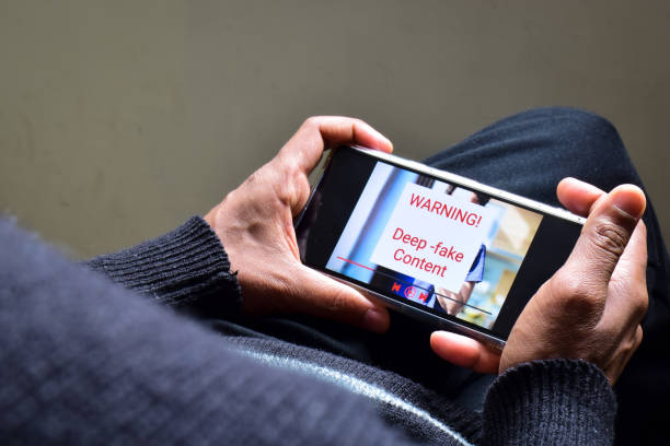 istock Person got potential deep fake content message during watching a footage on his mobile phone. Selective focus. 1961023985