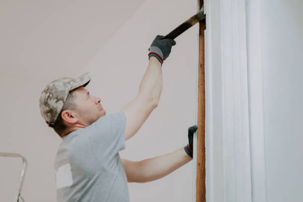 istock Hands of a man working with a crowbar indoors. 1961033975