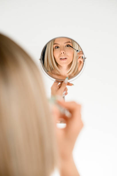 istock Reflection in a round mirror of a pretty woman's face 1961046591