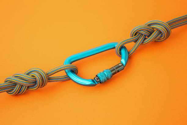 istock One metal carabiner with ropes on orange background 1961061289