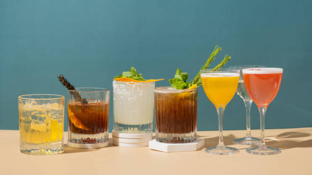 istock Composition with alcoholic cocktails on podium with ice on colored background. 1961071289