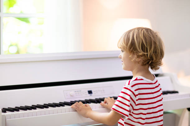 istock Child playing piano. Kids play music. 1961071309