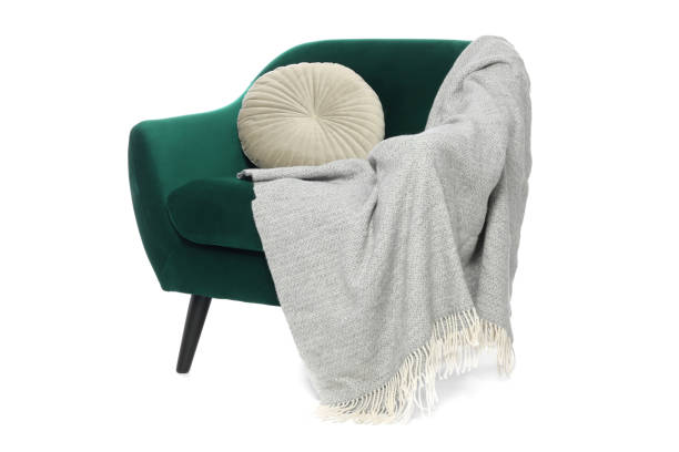 istock One stylish comfortable armchair with pillow and blanket isolated on white 1961073443