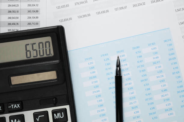 istock Calculator and pen on documents with financial calculations, flat lay 1961074496