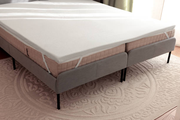 istock White memory foam mattress topper on grey bed indoors 1961075561