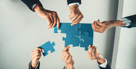 Top view panorama banner of business team assembling jigsaw puzzle over table symbolize business partnership and collective teamwork for HR recruitment and job seeker background. Shrewd