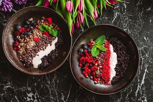 Black rice bowl with berries, cocoa nibs, granola and soy yoghurt - veganuary edition