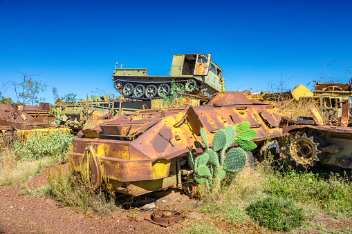 Military vehicles in a stack at a junkyard in Asmara, the capital of Eritrea, on a sunny day.