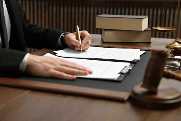 istock Lawyer working with documents at wooden table indoors, closeup 1961176173