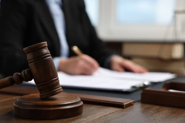 istock Lawyer working with documents at wooden table indoors, focus on gavel 1961176699