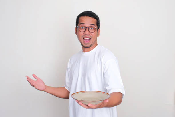 istock Adult Asian man showing empty dinning plate with wow face expression 1961176700