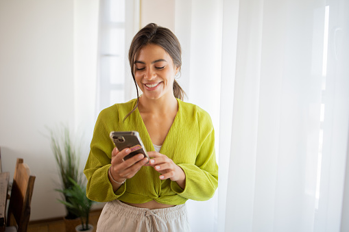 Portrait of a young woman using smartphone