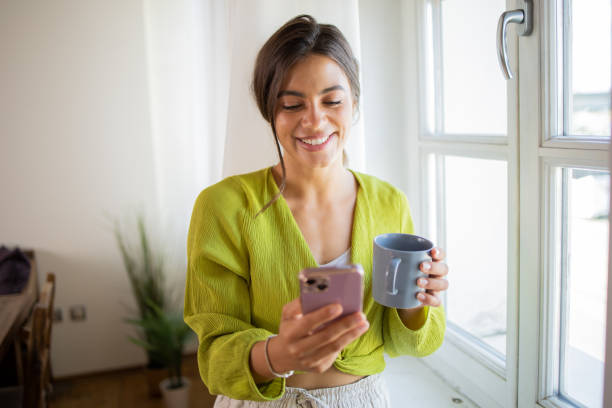 istock Happy young woman using phone 1961182481
