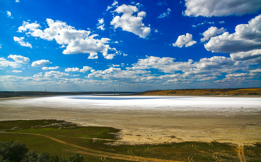 Kuyalnitsky estuary - a salt desert on the site of a drying pond, white thunderclouds before the rain. Ecological problem of the south of Ukraine