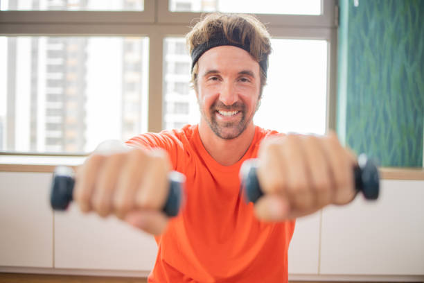 istock Young man at home keeping fit by exercising 1961215371