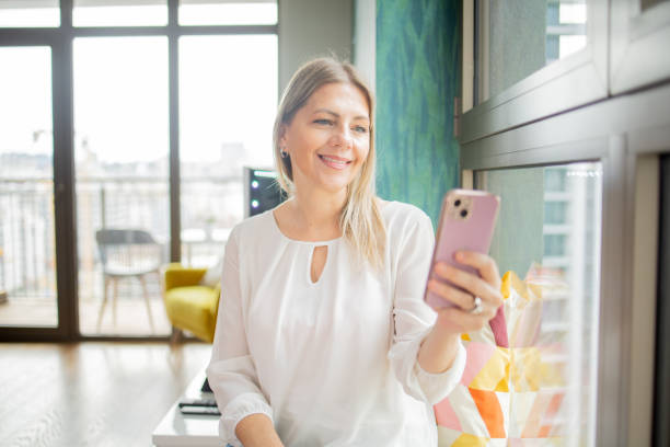 istock Happy mature woman using phone 1961219632
