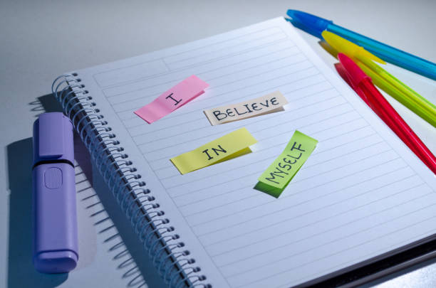 istock Pastel colors stickers notes with quote I believe in myself over a spiral notebook. 1961269667